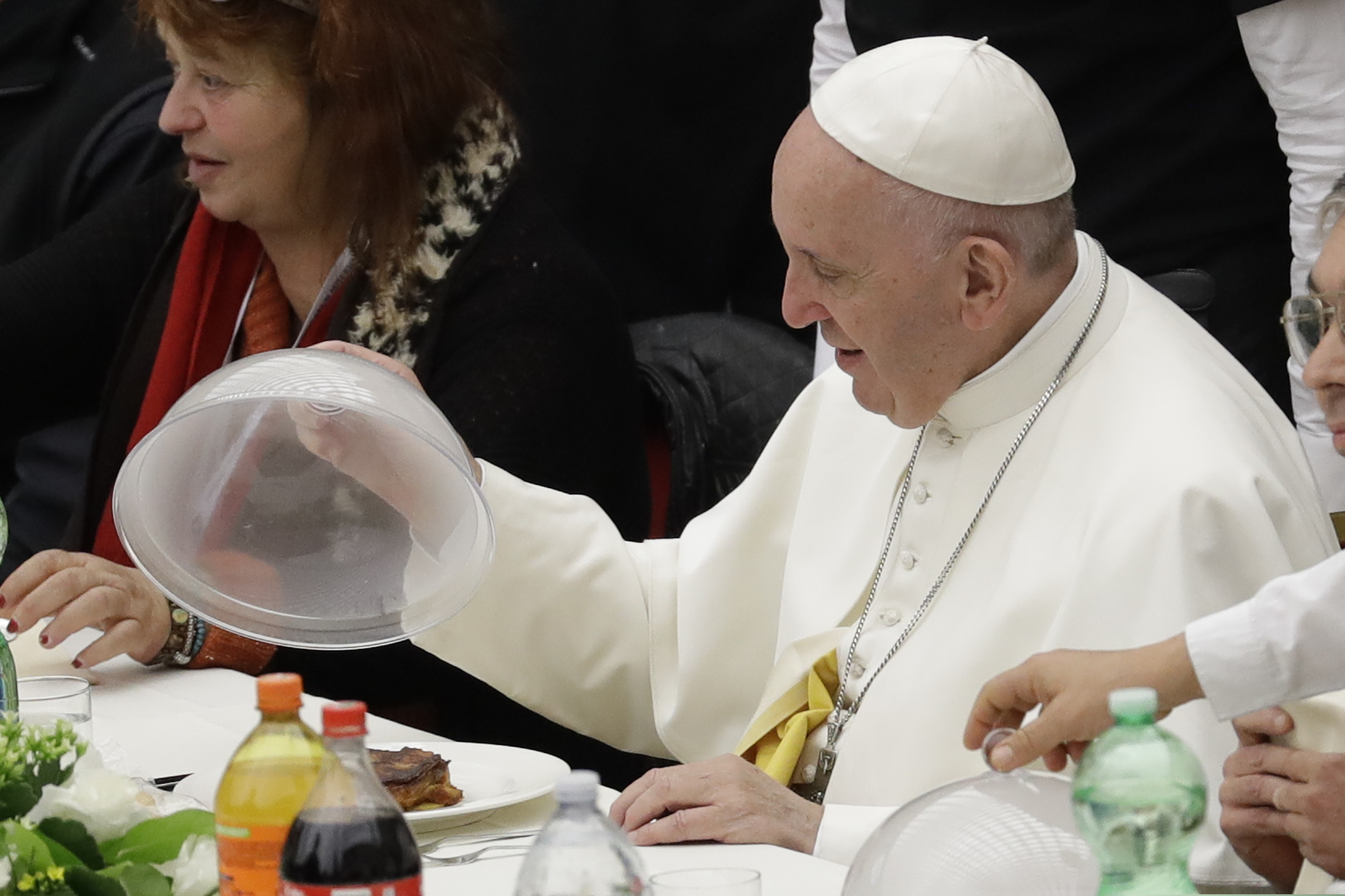 (AP Photo/Andrew Medichini) Pope Francis uncovers a dish of lasagna during a lunch, at the Vatican, Sunday, Nov. 18, 2018. Pope Francis is offering several hundred poor people, homeless, migrants, unemployed a lunch on Sunday as he celebrates the World Day of the Poor with a concrete gesture of charity in the spirit of his namesake, St. Francis of Assisi.