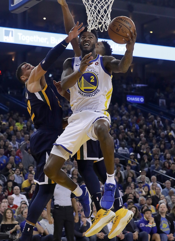 Golden State Warriors forward Jordan Bell (2) shoots against Utah Jazz forward Thabo Sefolosha, left, and guard Donovan Mitchell during the first half of an NBA basketball game in Oakland, Calif., Wednesday, Dec. 27, 2017. (AP Photo/Jeff Chiu)