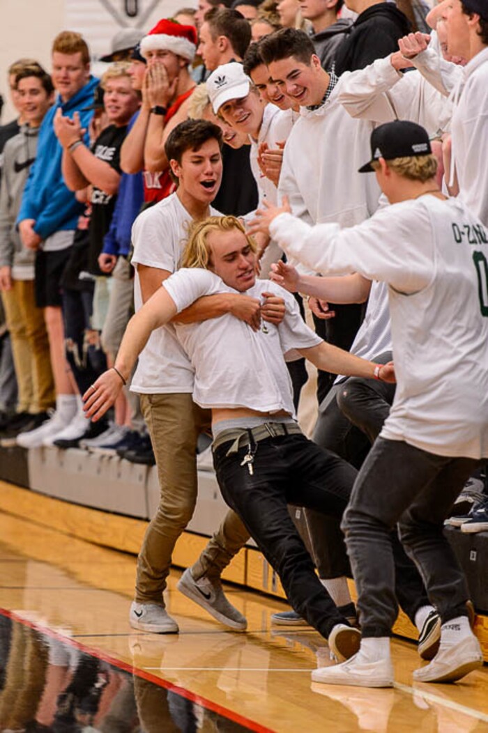 (Trent Nelson | The Salt Lake Tribune)  Olympus fans react to one of Olympus's Caden Kuhn's three-pointers and a 34-point lead as American Fork hosts Olympus in the Utah Elite Eight tournament, Saturday December 9, 2017.