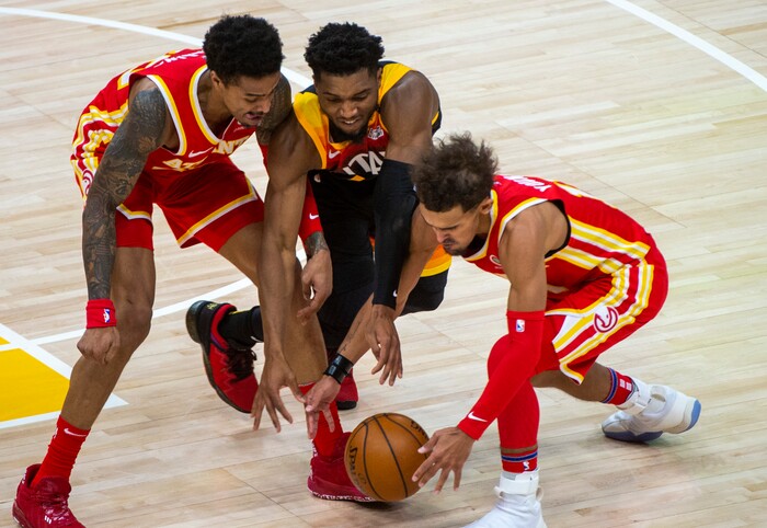 (Rick Egan | The Salt Lake Tribune) Utah Jazz guard Donovan Mitchell (45) goes for a loose ball along with Atlanta Hawks forward John Collins (20) and Atlanta Hawks guard Trae Young (11), in NBA action between the Utah Jazz and the Atlanta Hawks at Vivint Arena, on Friday, Jan. 15, 2021.