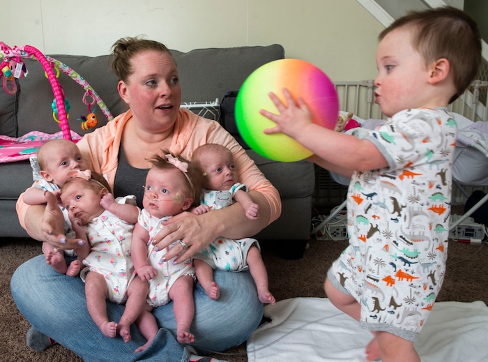 (Rick Egan  |  The Salt Lake Tribune)       Kayla Glines holds quadruplets, Reese, Lincoln, Oaklee and Jamesen as her son Parker walks into the picture, at her home in Ogden, Saturday, June 15, 2019.