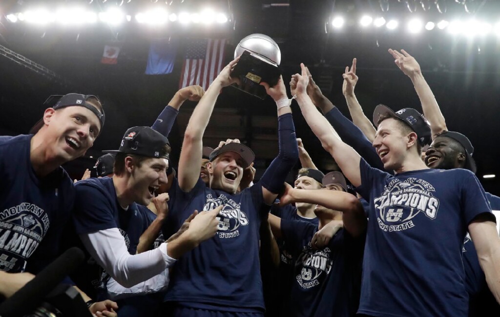 Utah State's Sam Merrill hoist the trophy for MVP after defeating San Diego State in an NCAA college basketball game for the Mountain West Conference men's tournament championship Saturday, March 7, 2020, in Las Vegas. (AP Photo/Isaac Brekken)