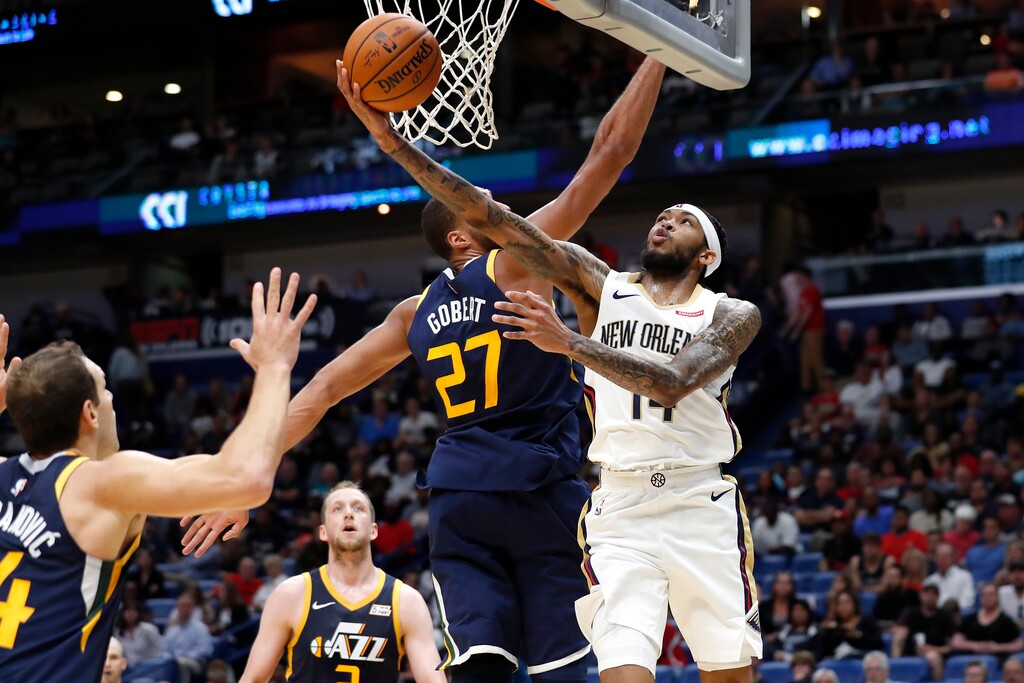 New Orleans Pelicans forward Brandon Ingram (14) shoots next tp Utah Jazz center Rudy Gobert (27) during the first half of a preseason NBA basketball game in New Orleans, Friday, Oct. 11, 2019. (AP Photo/Tyler Kaufman)