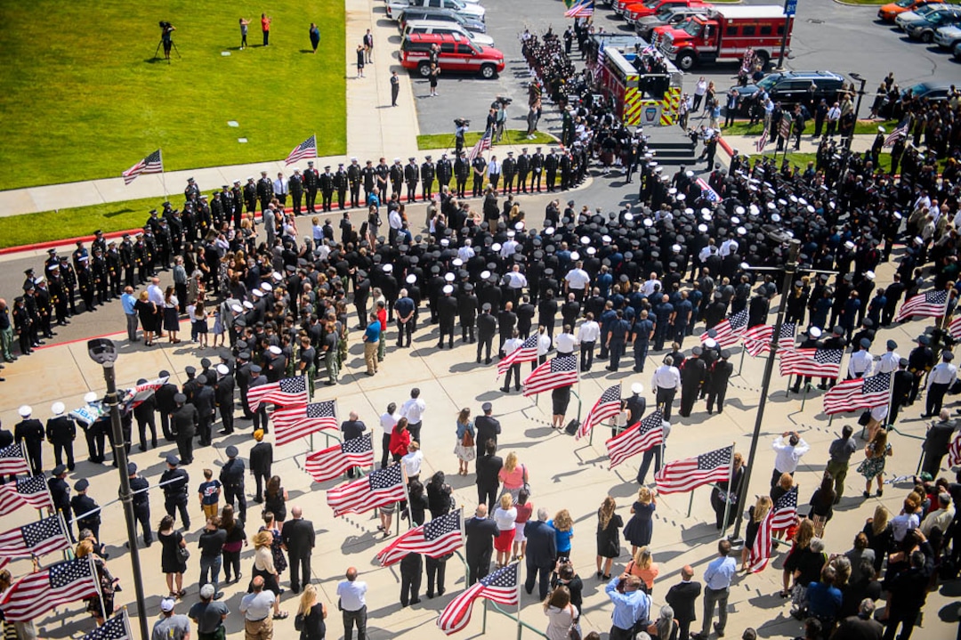 (Trent Nelson | The Salt Lake Tribune)  Funeral services for Battalion Chief Matthew Burchett at the Maverik Center in West Valley City, Monday Aug. 20, 2018.