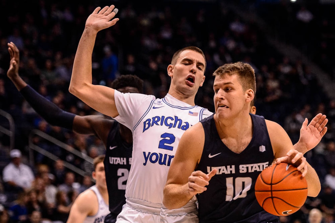 (Trent Nelson | The Salt Lake Tribune)  Utah State Aggies forward Quinn Taylor (10) and Brigham Young Cougars guard Zac Seljaas (2) as BYU hosts Utah State, NCAA basketball in Provo on Wednesday Dec. 5, 2018.