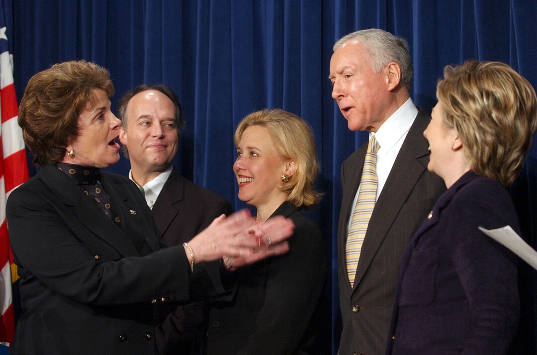 (Susan Walsh | AP) Sen. Diane Feinstein, D-Calif., left, shares a laugh with Sen. Orrin Hatch, R-Utah., second from right, during a news conference on Capitol Hill, Thursday, March 13, 2003 to urge the House to pass Amber Alert legislation. Also participating in the news conference is Sen. Peter Fitzgerald, R-Ill., Sen. Mary Landrieu, R-La., and Sen. Hillary Rodham Clinton, D-N.Y., right. 