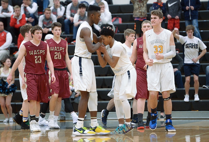 (Leah Hogsten  |  The Salt Lake Tribune) Summit Academy's Isaiah Green kisses the hand of Jalexus Gilson who just sunk his foul shot to even the score and send the game into overtime. Juab High School boys' basketball team defeated Summit Academy 61-58 during their 3A State tournament game in Heber Saturday, Feb. 17, 2018.
