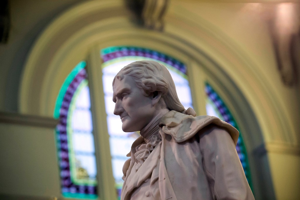 FILE - This Feb. 17, 2016 file photo shows statue of Thomas Jefferson greeting visitors in the main lobby of the Jefferson Hotel in Richmond, Va. (AP Photo/Steve Helber, File)