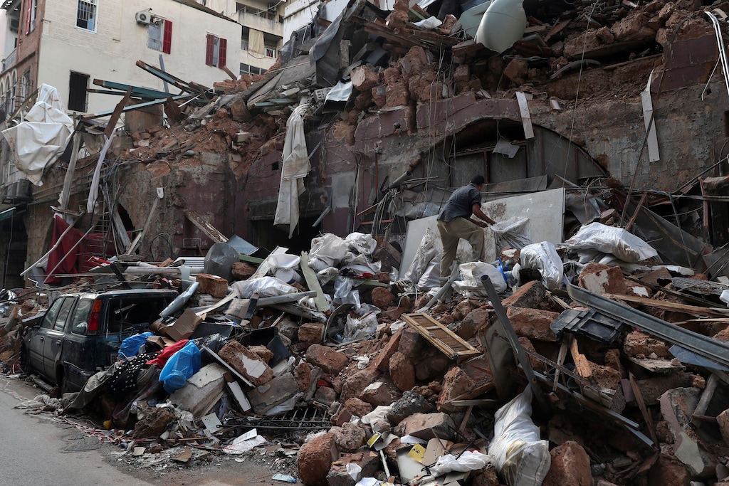 (Bilal Hussein | AP file photo)  A man inspects a destroyed building Monday near the site of last week's explosion that hit the seaport of Beirut, Lebanon.