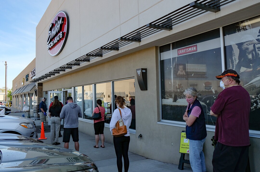 (Francisco Kjolseth  |  The Salt Lake Tribune) People line up outside of Snider Brothers Meats in Cottonwood Heights on Tuesday, May 5, 2020, as they limit the number of people inside the store.
