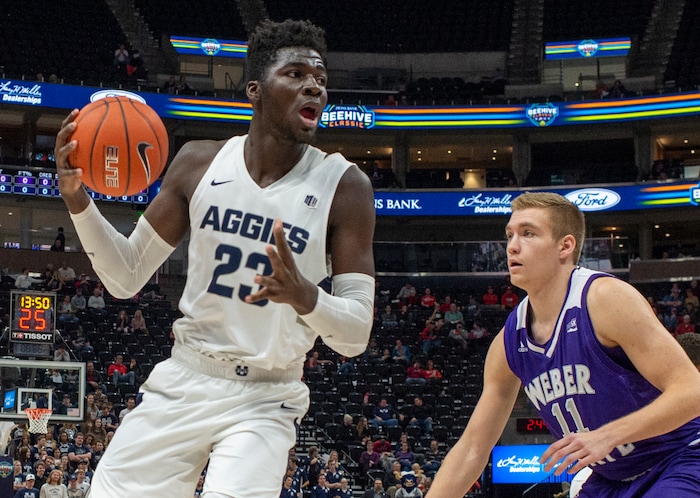 (Rick Egan  |  The Salt Lake Tribune)   Utah State Aggies center Neemias Queta (23) controls the ball, as Weber State Wildcats forward Michal Kozak (11) defends, in basketball action in the Beehive Classic, between against the Utah State Aggies and Weber State Wildcats, a the Vivint Smart Home Arena, Saturday December 8, 2018.

 