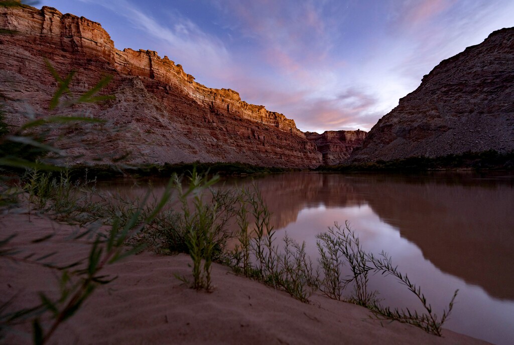 (Francisco Kjolseth | The Salt Lake Tribune) The rising sun lights up the rim above the confluence of the Green and Colorado Rivers marking the start of Cataract Canyon in Canyonlands Utah in mid-October 2021. 