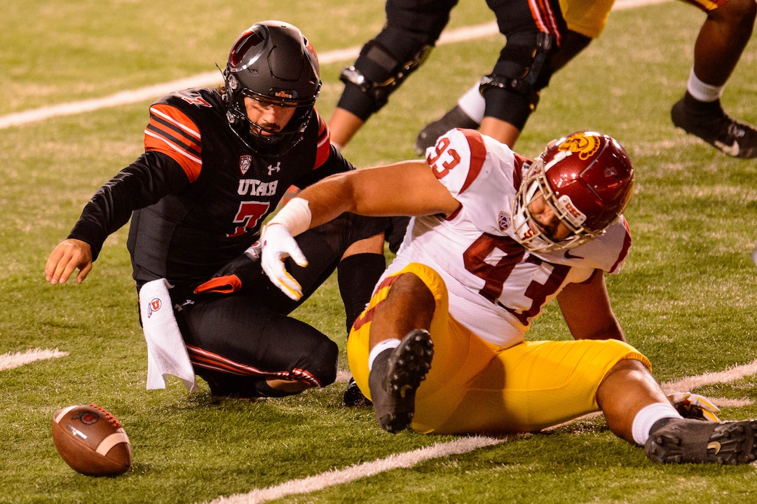 (Trent Nelson  |  The Salt Lake Tribune) Utah Utes quarterback Cameron Rising (7) tries to recover the ball he fumbled as he's hit by USC Trojans defensive lineman Marlon Tuipulotu (93), as the Utah Utes host the USC Trojans, NCAA football at Rice-Eccles Stadium in Salt Lake City on Saturday, Nov. 21, 2020.