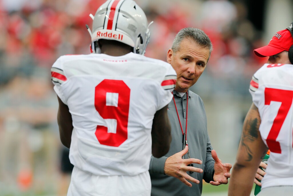 Ohio State head coach Urban Meyer, right, talks with receiver Binjimen Victor during their NCAA college spring football game Saturday, April 14, 2018, in Columbus, Ohio. (AP Photo/Jay LaPrete)