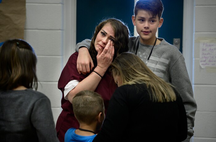(Scott Sommerdorf   |  The Salt Lake Tribune)   Inmate Dianna Robles says goodbye to her children Brooklyn, left, Cameron, below, her sister Kollette, center, and Demitrie, right, at the end of "Kids Day" at the Utah State Prison, Saturday, October 7, 2017.