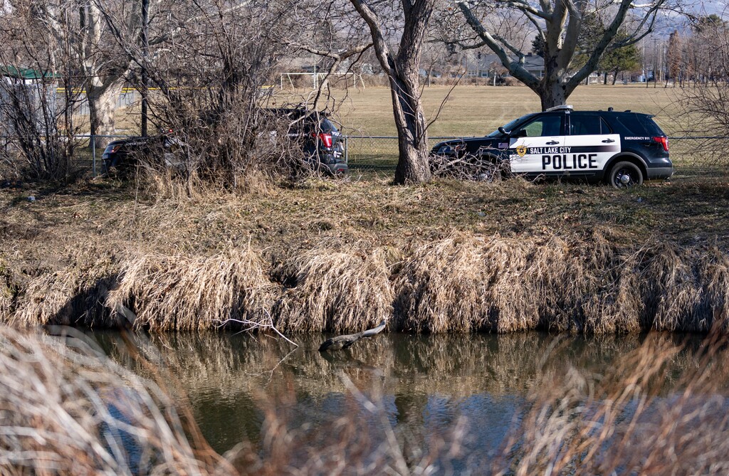 (Francisco Kjolseth | The Salt Lake Tribune) Police detectives and the homicide unit respond to the scene of a body found in the Jordan River near 700 North in Salt Lake City on Thursday, Jan. 27, 2022.