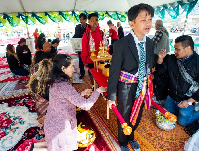 (Rick Egan  |  The Salt Lake Tribune)    AJ Bhanthamisay leads the procession during the Bak Baht, at the Wat Lao Salt Lake Buddharam Utah, New Year Celebration, in West Valley City, Sunday, April 28, 2019.



