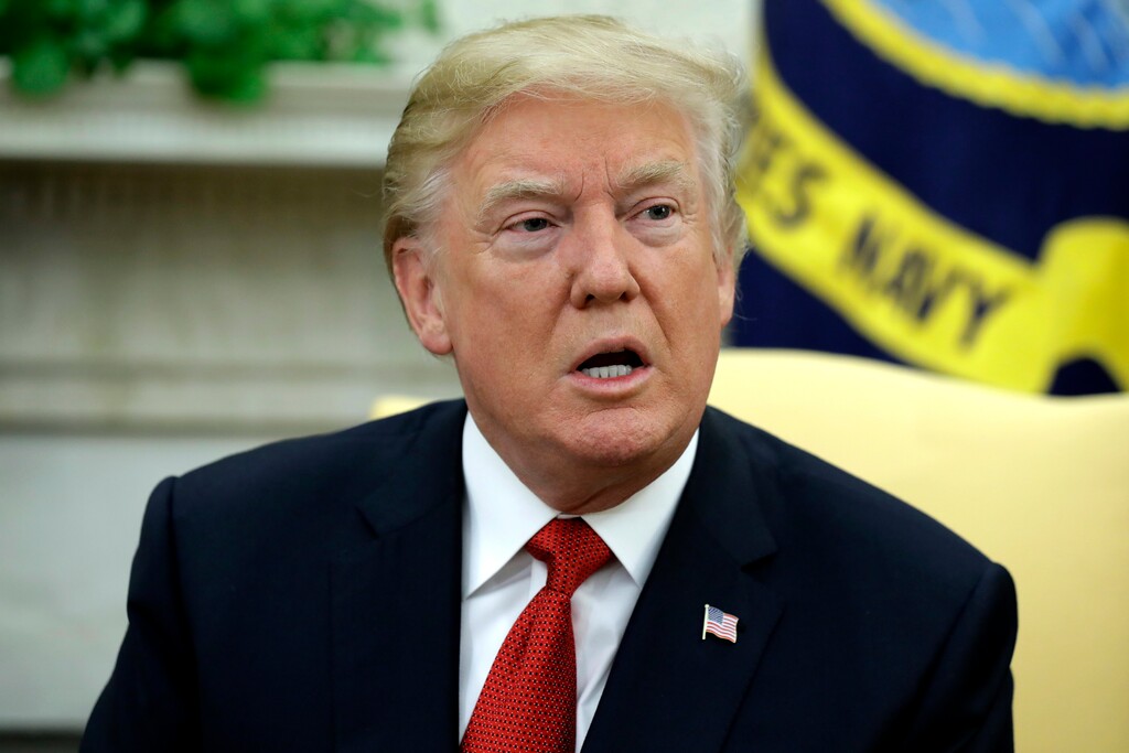 (Evan Vucci | The Associated Press) In this Monday, Oct. 23, 2017, file photo, President Donald Trump speaks during a meeting in the Oval Office of the White House in Washington. Trump is unleashing new criticism of the probes into possible ties between his campaign associates and Russia.