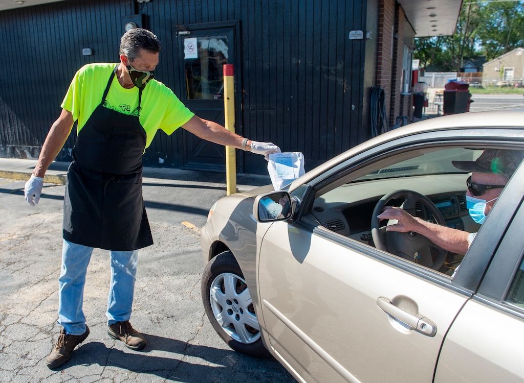 (Rick Egan  |  The Salt Lake Tribune) Van Turner delivers food to Reed Riddle, at the Hook and Ladder Fire Station #13 in Glendale, on Friday, June 26, 2020.