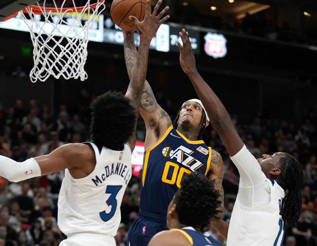 (Francisco Kjolseth | The Salt Lake Tribune) Utah Jazz guard Jordan Clarkson (00) lands a massive dunk while pressured by Minnesota Timberwolves forward Jaden McDaniels (3) and Minnesota Timberwolves center Naz Reid (11) in NBA action between the Utah Jazz and the Minnesota Timberwolves at Vivint Smart Home Arena in Salt Lake City, Thursday, Dec. 23, 2021.