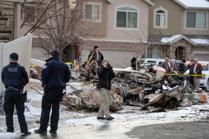 (Leah Hogsten | The Salt Lake Tribune) Weber County emergency personnel and firefighters work the scene of a small, private plane that crashed in a residential neighborhood in Roy, Jan. 15, 2020. A 64-year-old pilot was killed.