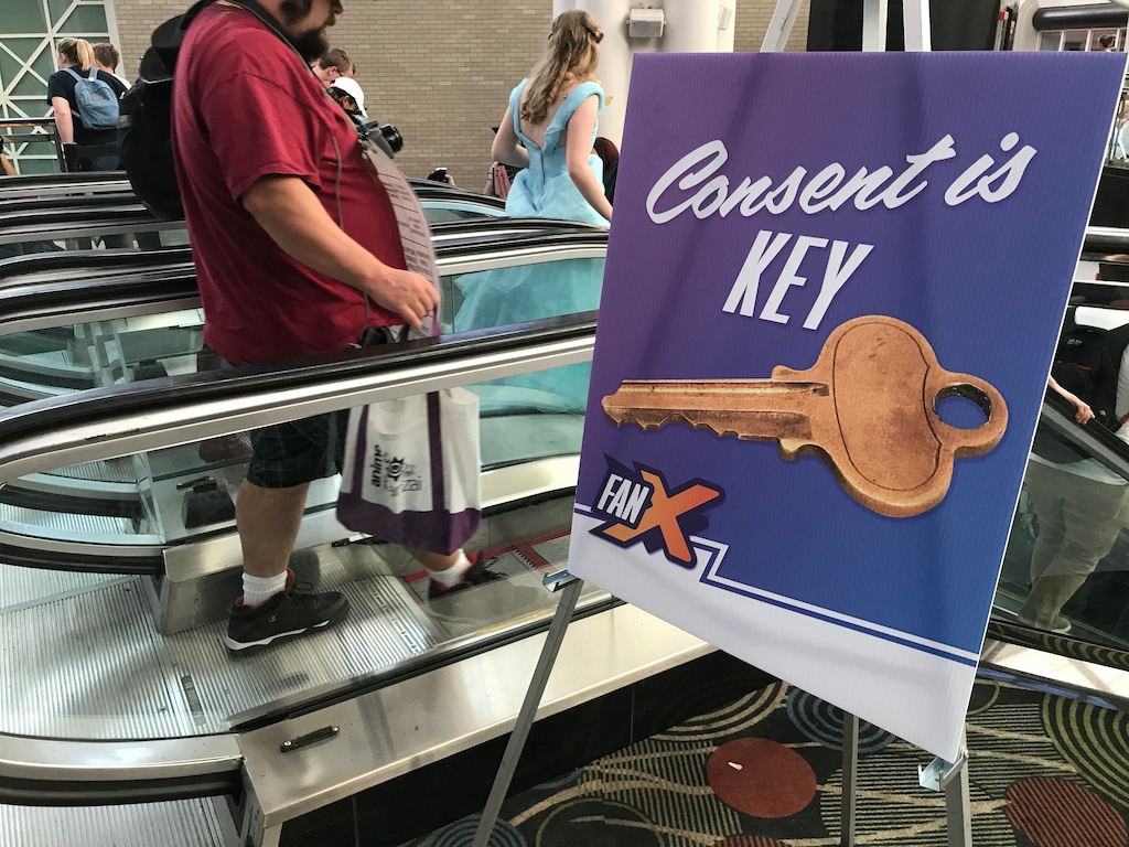 (Paighten Harkins | The Salt Lake Tribune) A "Consent is KEY" poster is displayed next to the escalator during the FanX Salt Lake Comic Convention on Saturday, Sept. 8, 2018, at the Salt Palace Convention Center. Convention officials were accused of mishandling an allegation of sexual harassment after the fall 2017 convention.