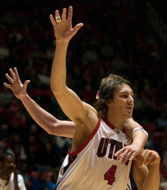 Utah's Andrew Bogut battles for position against Weber State's Lance Allred during first half action of the Utah Weber State game at the Huntsman Center Dec. 28, 2004. Griffin/photo