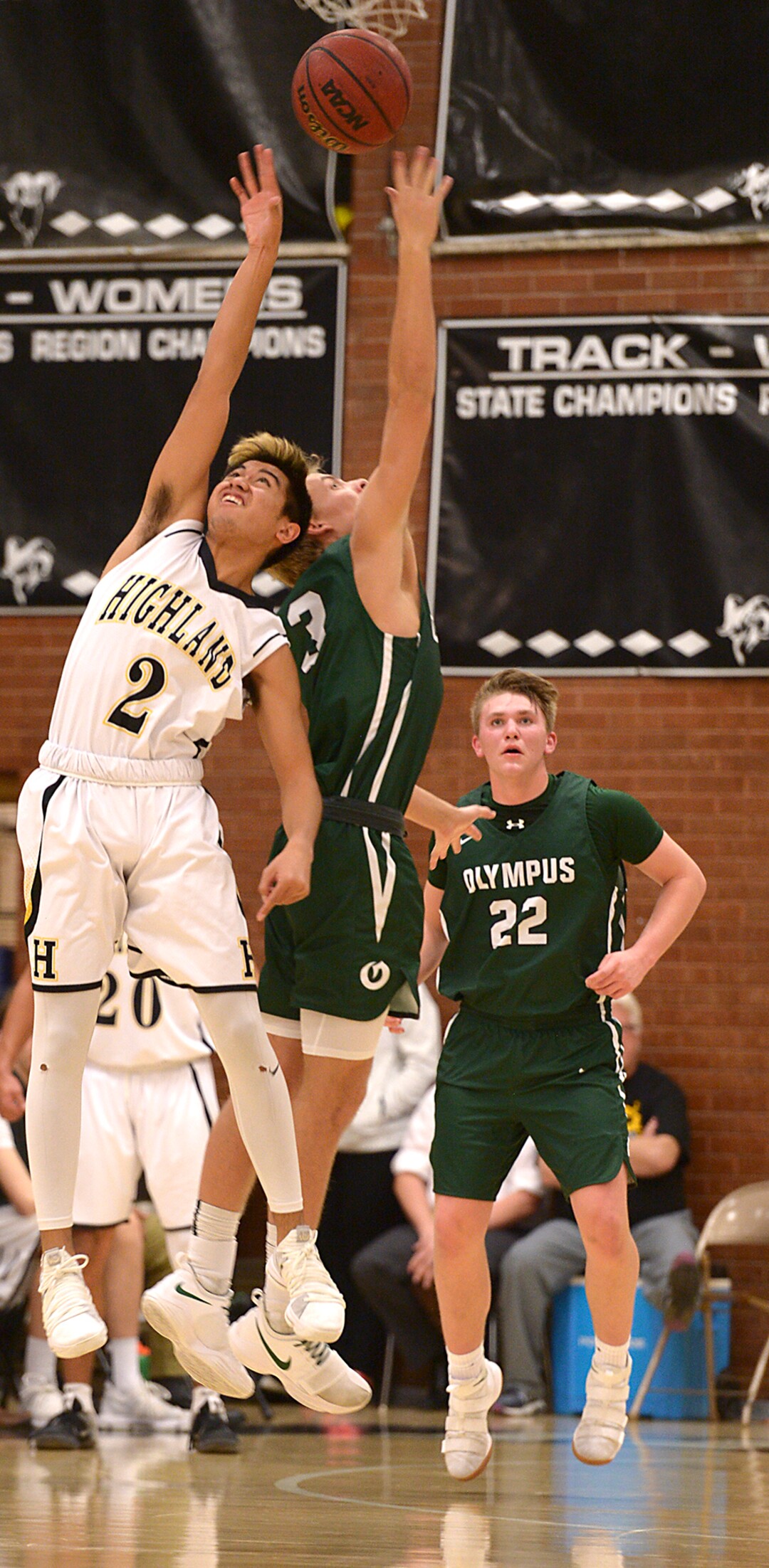(Leah Hogsten  |  The Salt Lake Tribune) Highland's Liki Makaui and Olympus' Sam Goats fight for possession. Olympus High School defeated Highland High School 86-54 during their basketball game, Tuesday, February 6, 2018.