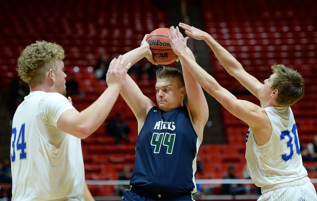 (Francisco Kjolseth | The Salt Lake Tribune)
Copper Hills center Trevon Allfrey (44) is pressured by Fremont's Owen Stewart (34) and Dallin Hall (30) during their Class 6A state quarterfinal Thursday at the Huntsman Center.