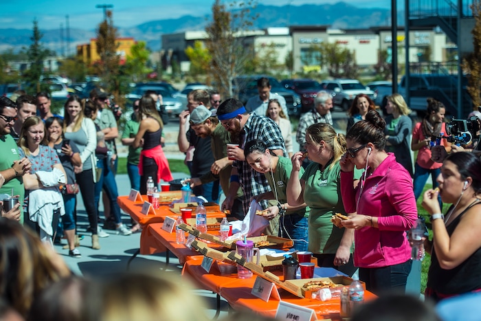 (Chris Detrick | The Salt Lake Tribune) Employees compete in a pizza eating competition during a fundraiser for United Way at CHG Healthcare Wednesday, September 20, 2017.