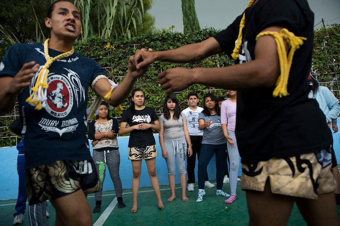In this Aug. 25, 2017 photo, Muay Thai practitioners demonstrate self-defense moves to mostly female students at a nursing school in Nezahualcoyotl, Mexico state. The mounting crisis of femicides _ murders of women where the motive is directly related to gender _ prompted the federal government to issue a gender violence alert in 2015, the first for any Mexican state. (AP Photo/Rebecca Blackwell)