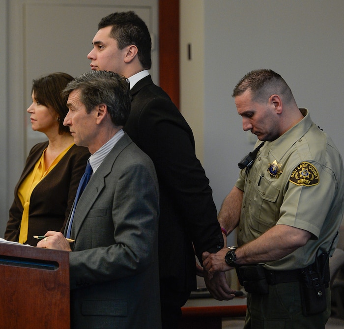 (Francisco Kjolseth  |  The Salt Lake Tribune)  Former Brighton High and University of Southern California linebacker Osa Masina, center, is taken into custody while standing with his defense attorney's Greg and Rebecca Skordas during his sentencing for sexual battery at the Matheson Courthouse in Salt Lake City on Tuesday, Dec. 5, 2017. Masina was sentenced to 365 days in jail, followed by two years on probation.