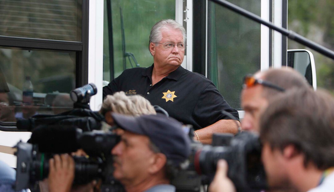 (Trent Nelson  |  The Salt Lake Tribune)  Emery County Sheriff Lamar Guymon surveys the media scene at the command post for the Crandall Canyon mine disaster on Aug. 9, 2007.