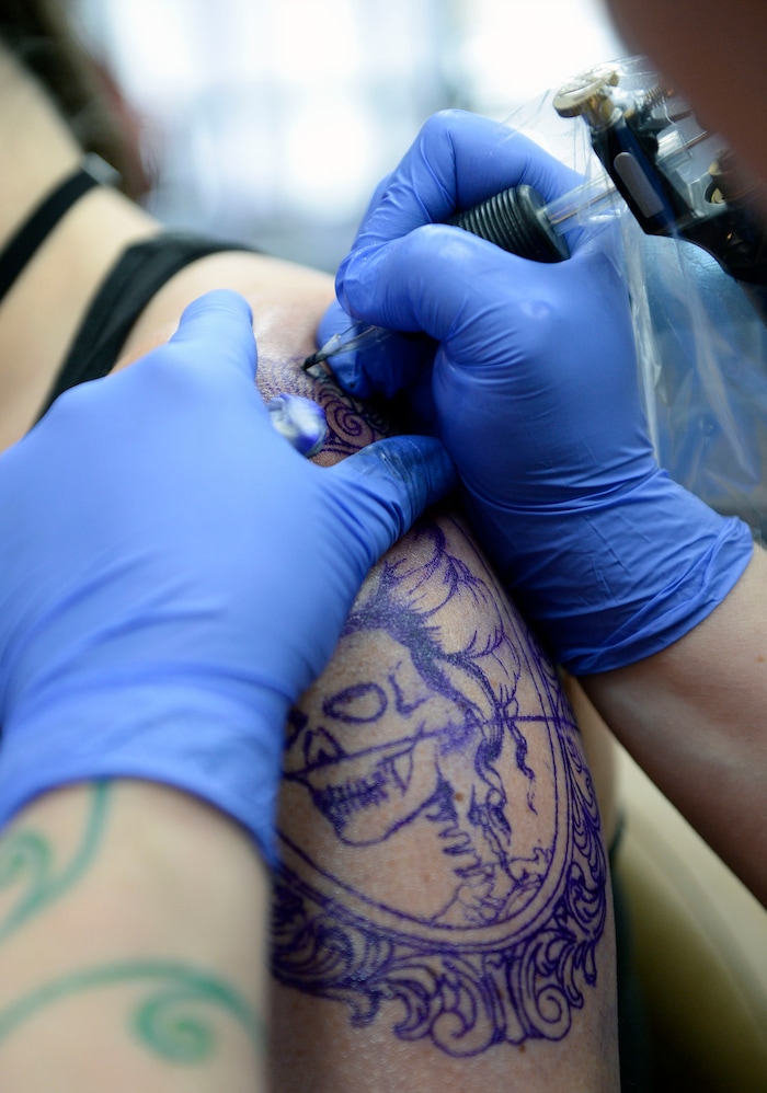 (Al Hartmann  |  The Salt Lake Tribune) 	
Terrina Francis, tatoo artist and owner of Fallen Angel Tattoo, is Salt Lake's only all-women tattoo studio.  She works on a personal tattoo for Shannon Gibbs.   The design is an old-fashioned cameo skull that she has thought about and wanted for four years.   Francis also offers to tattoo over scars and disfigurements due to domestic violence, breast cancer, and burns.   The shop offers a place where women can feel comfortable about getting tattooed in a very male-dominated field. 