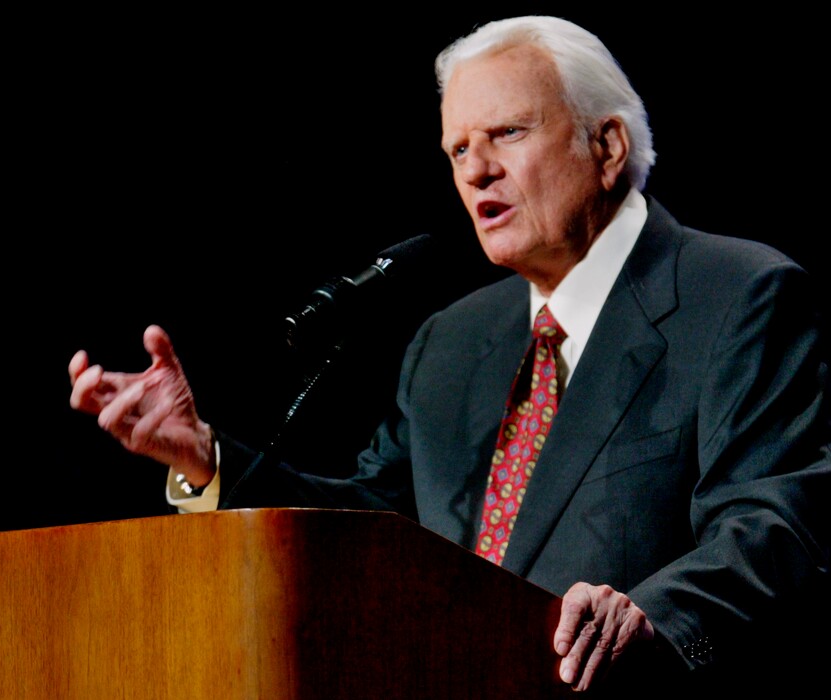 (AP Photo/Sue Ogrocki, File) In this June 12, 2003, photo, the Rev. Billy Graham preaches in Oklahoma City, Okla. Graham, who died Wednesday, Feb. 21, 2018, at his home in North Carolina's mountains at age 99, reached hundreds of millions of listeners around the world with his rallies and his pioneering use of television.