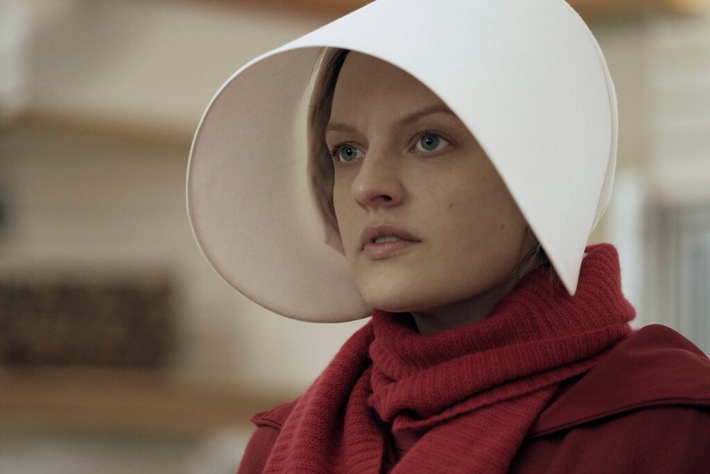 This image released by Hulu shows Elisabeth Moss as Offred in a scene from, "The Handmaid's Tale." The Television Critics Association presented its top award to the program during a ceremony Saturday. (George Kraychyk/Hulu via AP)