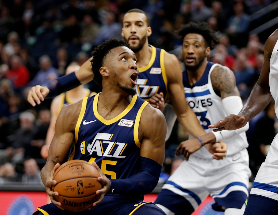 (Andy Clayton-King | AP) Utah Jazz guard Donovan Mitchell (45) drives on the Minnesota Timberwolves with Utah Jazz center Rudy Gobert and Minnesota Timberwolves forward Robert Covington behind the play during the first quarter of an NBA basketball game Wednesday, Nov. 20, 2019 in Minneapolis.