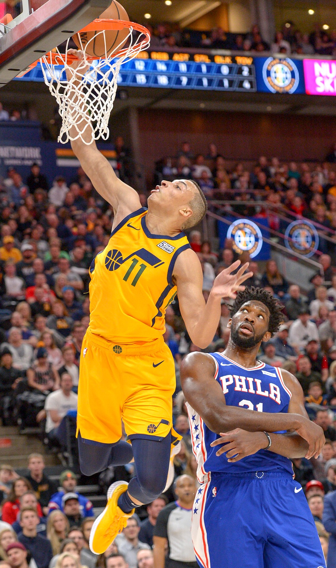 Leah Hogsten  |  The Salt Lake Tribune  Utah Jazz guard Dante Exum (11) dunks on Philadelphia 76ers center Joel Embiid (21) as the Utah Jazz host the Philadelphia 76ers at Vivint Smart Home Arena, Thursday, December 27, 2018. 
