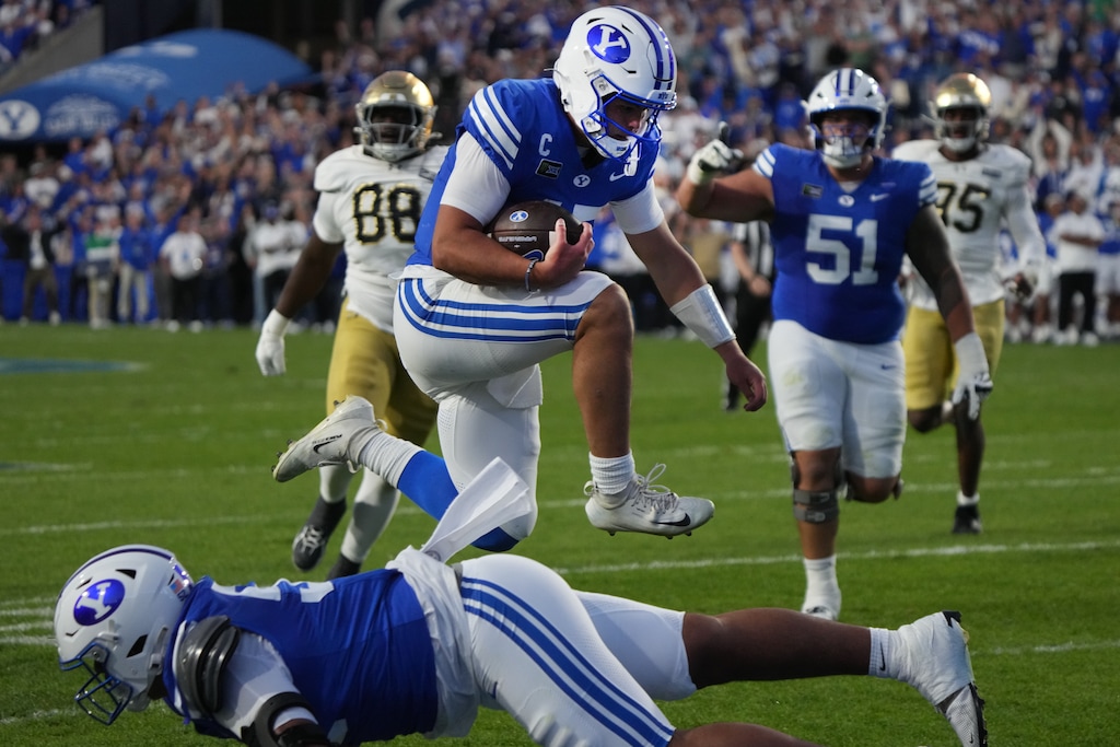 (George Frey | Special to The Tribune) BYU Cougars quarterback Bear Bachmeier (47) jumps over his teammate to go in for a touchdown during a game against Notre Dame Fighting Irish at LaVell Edwards Stadium on October 17, 2026.