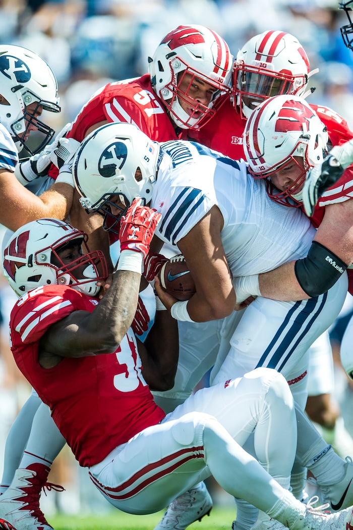 (Chris Detrick  |  The Salt Lake Tribune)  Wisconsin Badgers linebacker Leon Jacobs (32) Wisconsin Badgers defensive end Alec James (57) Wisconsin Badgers linebacker Chris Orr (54) and Wisconsin Badgers defensive end Conor Sheehy (94) tackle Brigham Young Cougars running back Ula Tolutau (5) during the game at LaVell Edwards Stadium Saturday Saturday, September 16, 2017. Wisconsin Badgers are leading Brigham Young Cougars 24-6 at halftime.