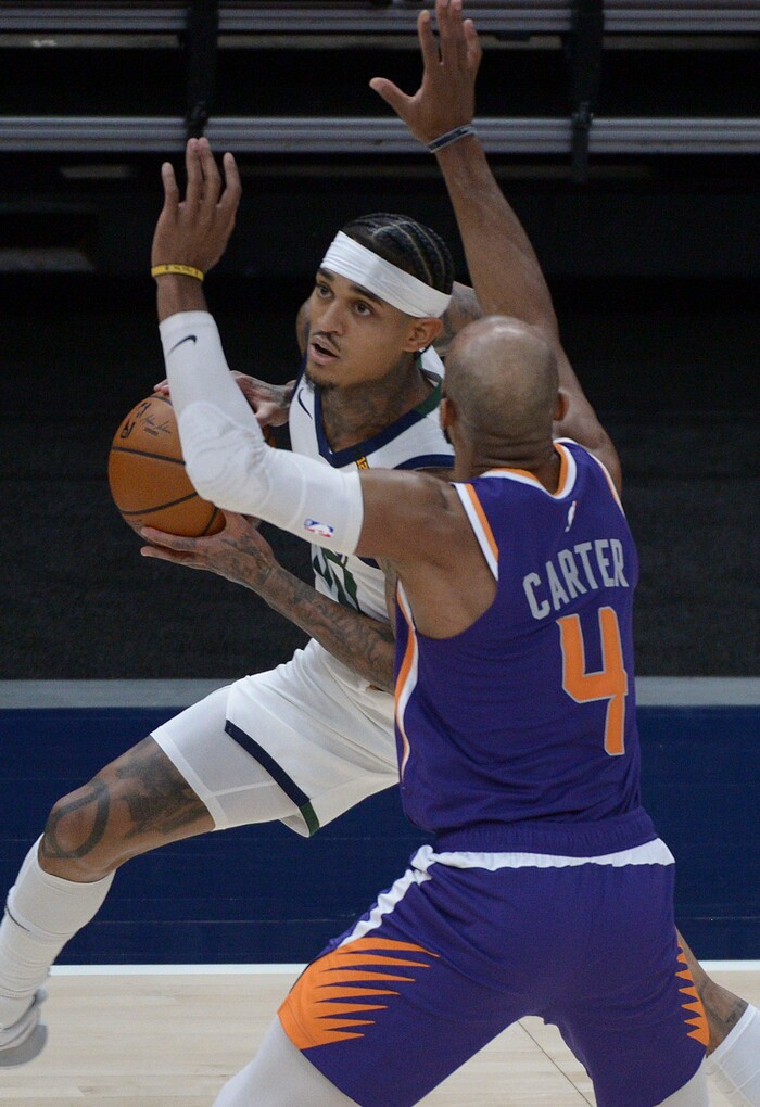 (Leah Hogsten | The Salt Lake Tribune) Utah Jazz guard Jordan Clarkson (00) drives around Phoenix Suns guard Jevon Carter (4) as the Jazz crack open their 2020-21 preseason with their second game against the Phoenix Suns, Dec. 14, 2020.