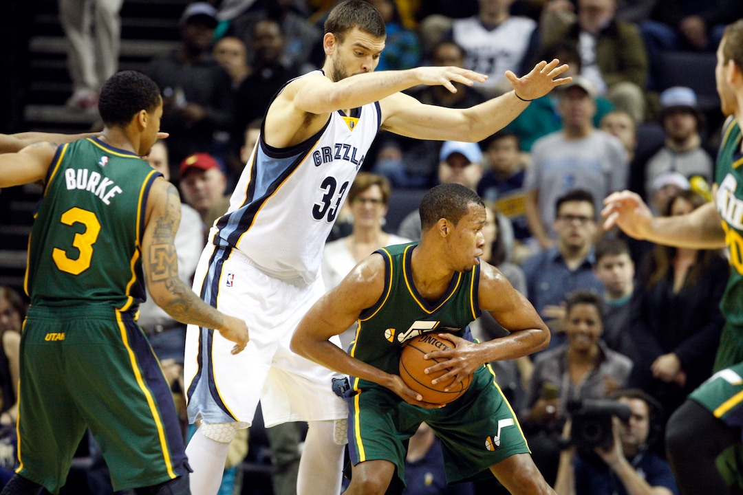 Memphis Grizzlies' Marc Gasol (33) guards Utah Jazz's Rodney Hood (5) in the second half of an NBA basketball game Monday, Dec. 22, 2014, in Memphis, Tenn. (AP Photo/Karen Pulfer Focht)