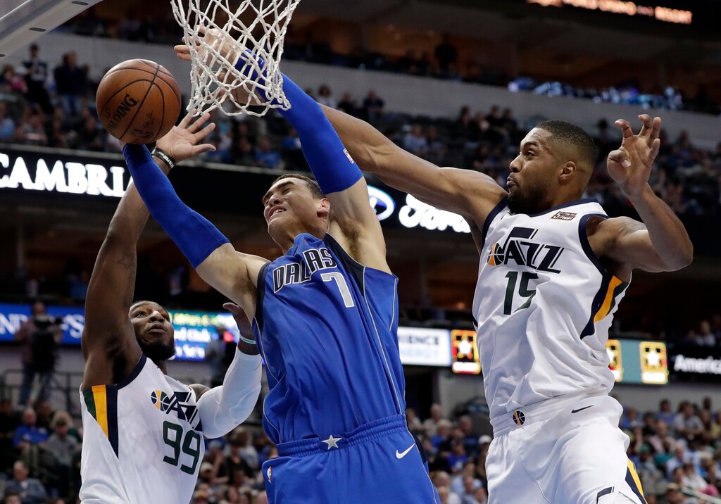 Utah Jazz forward Jae Crowder (99) and forward Derrick Favors (15) strip the ball away from Dallas Mavericks center Dwight Powell (7) on a shot attempt during the first half of an NBA basketball game Thursday, March 22, 2018, in Dallas. (AP Photo/Tony Gutierrez)