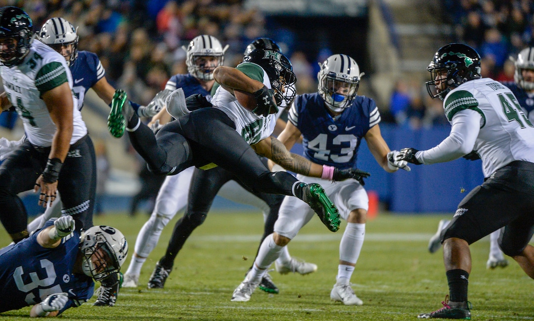 Leah Hogsten  |  The Salt Lake Tribune  Hawaii wide receiver JusticeAugafa (82) flies through the air after getting hit by Brigham Young Cougars running back Brayden El-Bakri (35) on a punt return as Brigham Young University hosts Hawaii at Lavell Edwards Stadium in Provo, Saturday Oct. 13, 2018. 