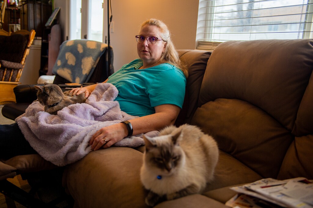 (Rachel Molenda | The Salt Lake Tribune) Moira Jackson-Drage in her home in Magna, Utah, on Friday, March 8, 2019. Jackson-Drage has fibromyalgia and neuropathy and struggles to afford her medicine. Her cats — B'Lana and Tiki — provide her with comfort, especially when she is having particularly bad days because of her chronic pain.