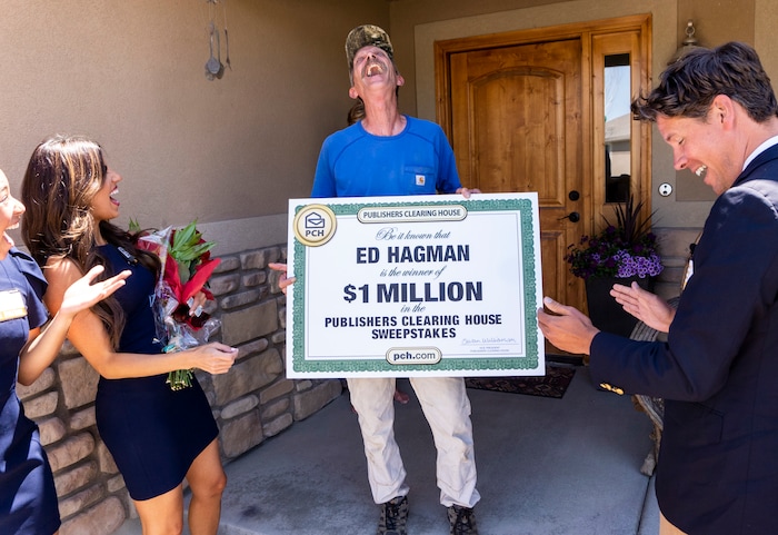 (Rick Egan | The Salt Lake Tribune) Members of the Prize Patrol from Publishers Clearing House, from left,  Bianca Quinnonez, Danielle Lam and  Howie Guja surprise Ed Hagman (center) with the news that he won $1,000,000, at his home in Herriman, on Friday, May 28th