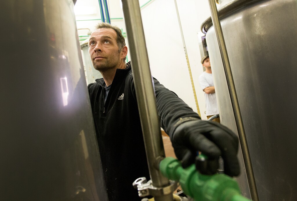 (Leah Hogsten  |  Tribune file photo)  Shades Brewing Co.'s brewer Trent Fargher checks the water temperate as they get ready to mash a craft beer. May 10, 2017.