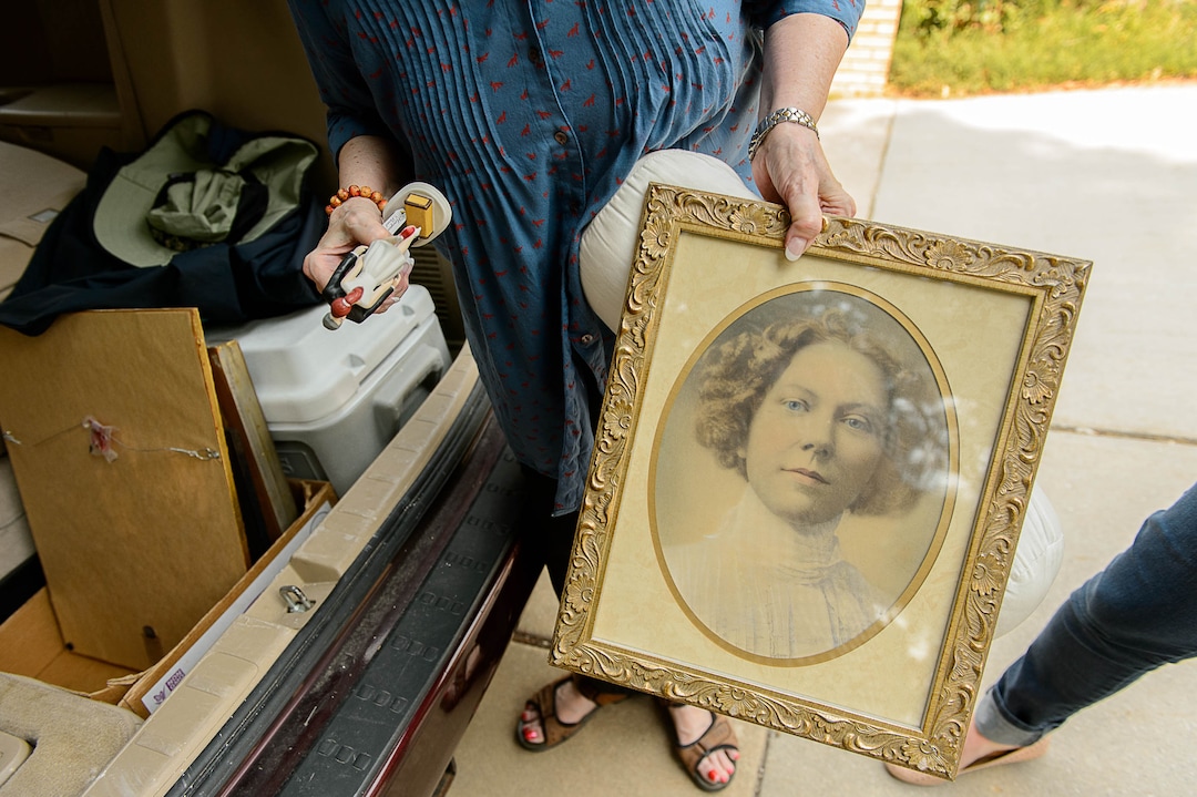 (Trent Nelson | The Salt Lake Tribune)  Carolyn Jacobson holds a photo of her grandmother and an ornament from her wedding, while evacuating her home as a fire burns at the mouth of Weber Canyon, Tuesday September 5, 2017.