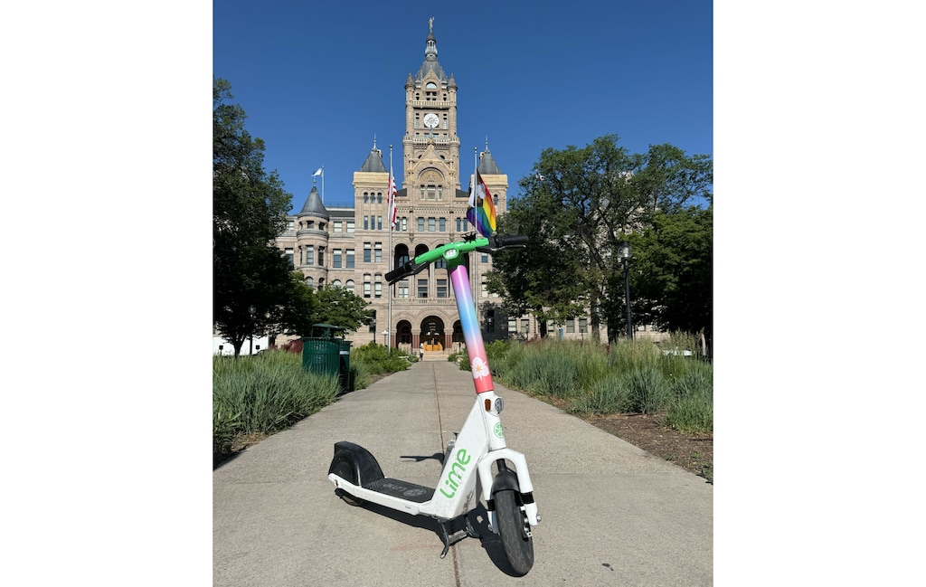 (Lime) A photo of a Lime scooter wrapped in colors inspired by Salt Lake City's 'Sego Belonging Flag.' The scooters will be around the entire month of June.