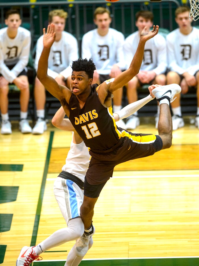 (Steve Griffin  |  The Salt Lake Tribune) Davis forward Brendon Redford gets fouled as he goes to the basket during the Granger versus Davis 6A basketball playoff game at Utah Valley UniversityÕs UCCU Center in Provo Tuesday Feb. 27, 2018.